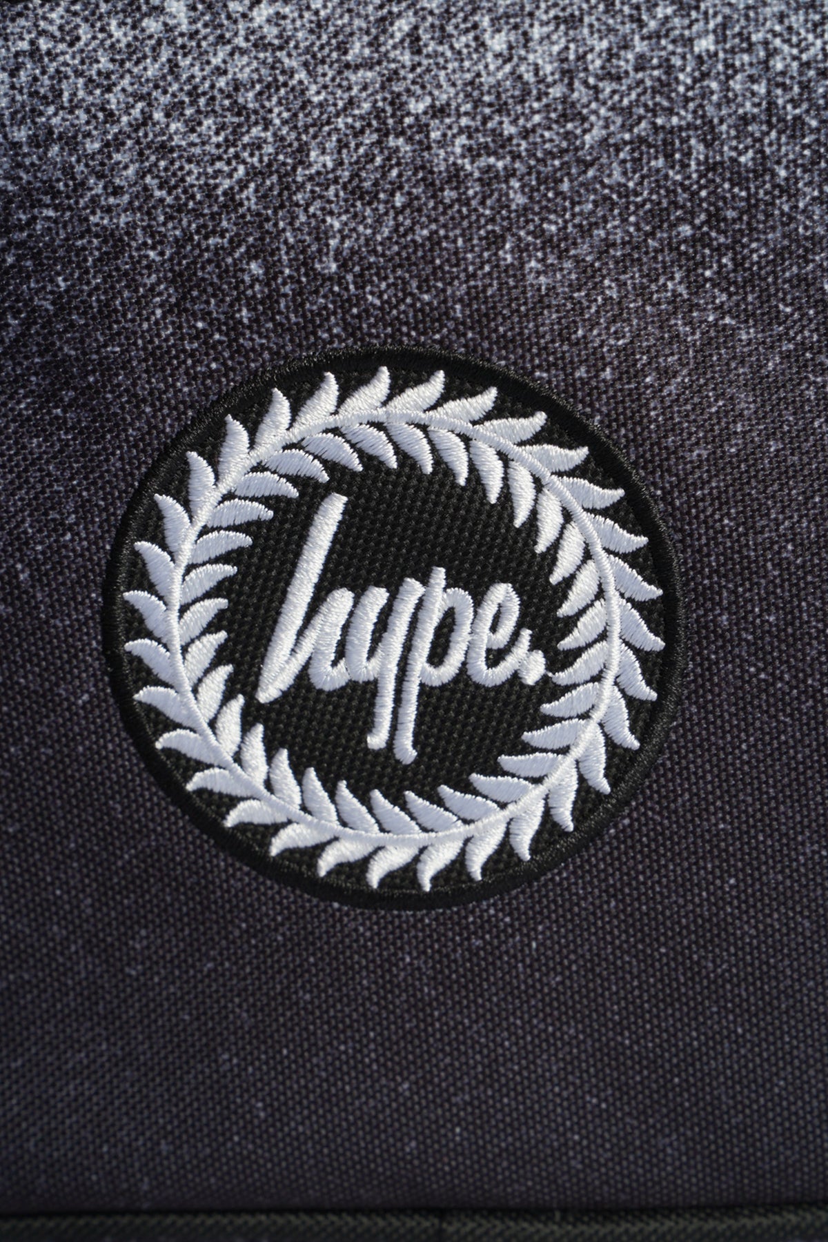 Hype Black & White Speckle Fade insulated lunch bag — close-up of logo and design details