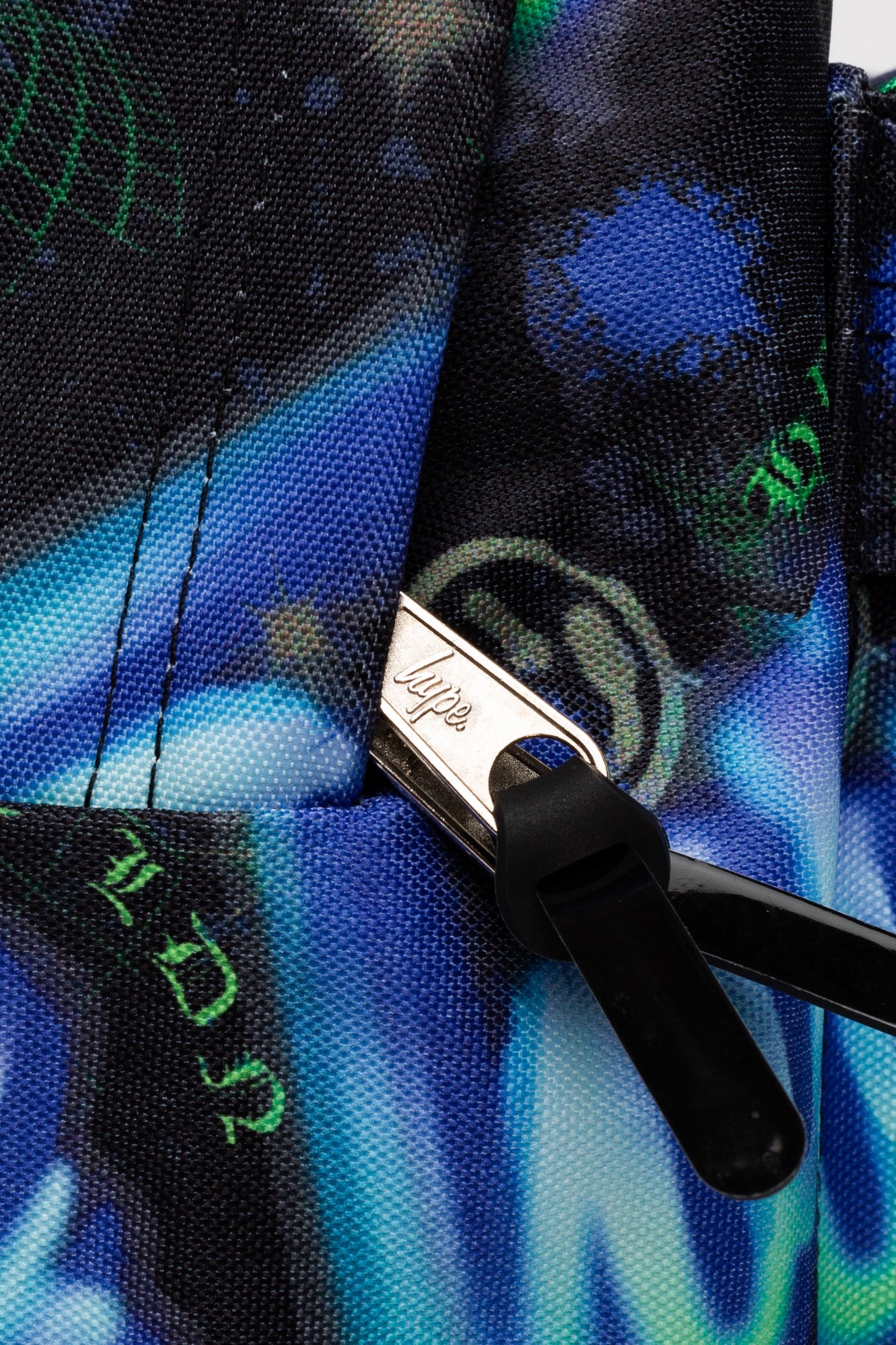 Hype Blue & Green Electric Smile backpack interior — main compartment and front pocket detail